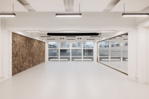 Licht en modern interieur van een lege ruimte aan de Generaal Vetterstraat met grote ramen, glazen wand en kurkwand.